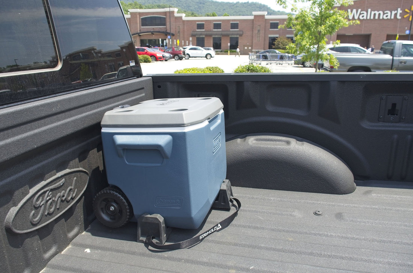 Stayhold CARGO WEDGE 2-PACK + TETHER. (Solid Rubber Cargo Chocks) holding a cooler